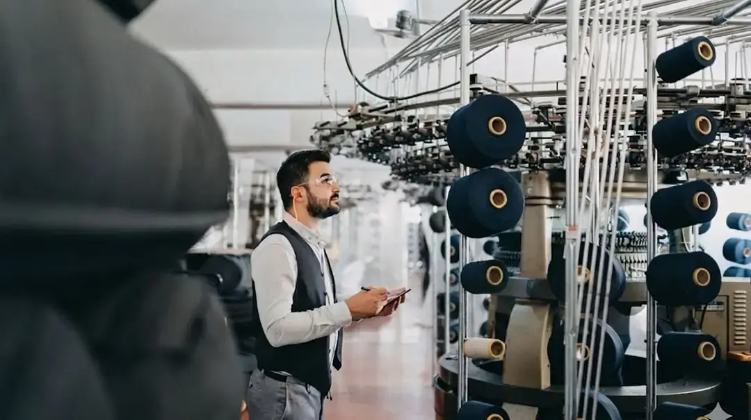http://Quality%20control%20personnel%20monitoring%20yarn%20winding%20machinery%20during%20textile%20manufacturing%20in%20a%20clean,%20organised%20factory.